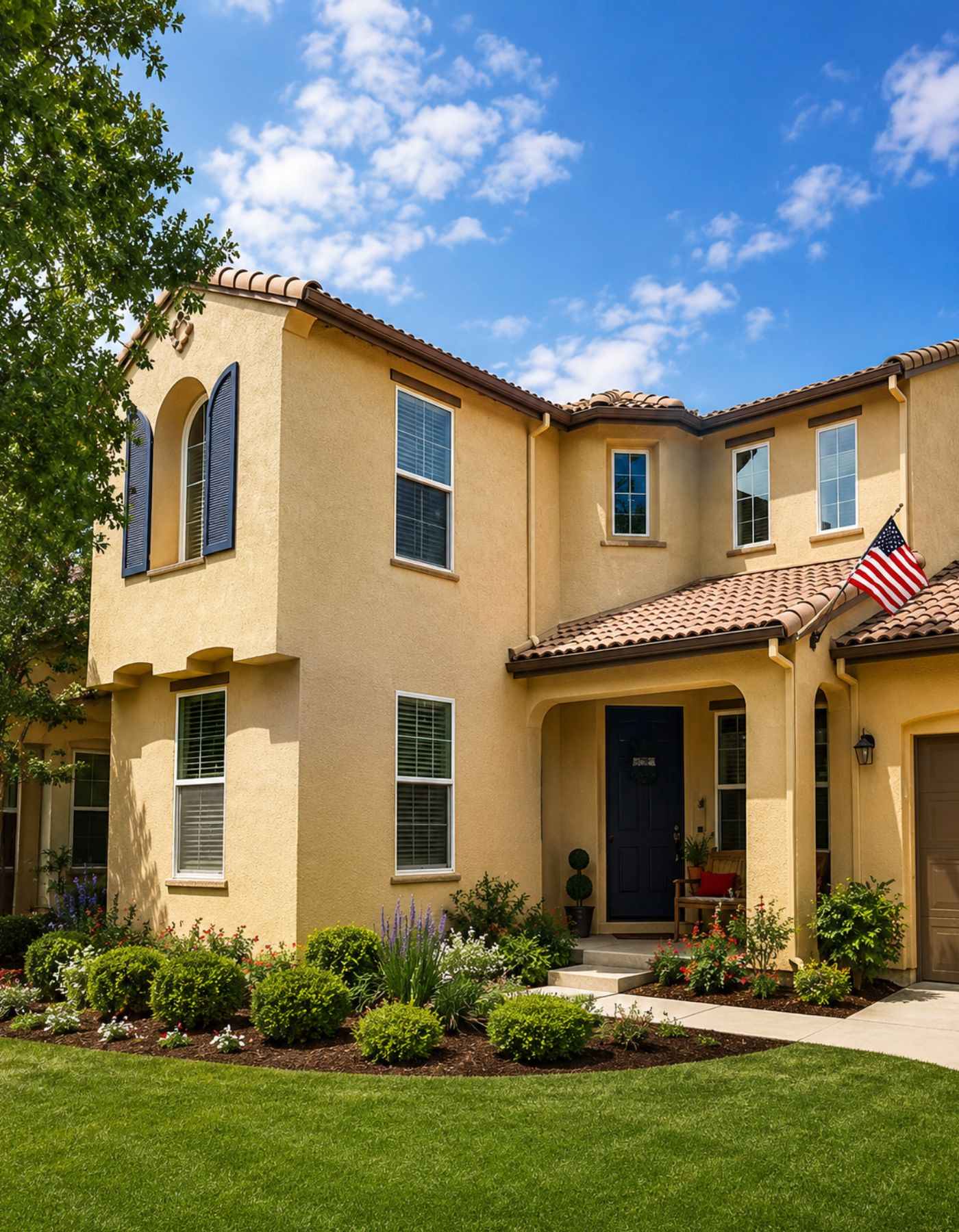 Freshly painted modern two-story home in Folsom CA with white stucco, gray trim, and dark garage door by TRICO Painting